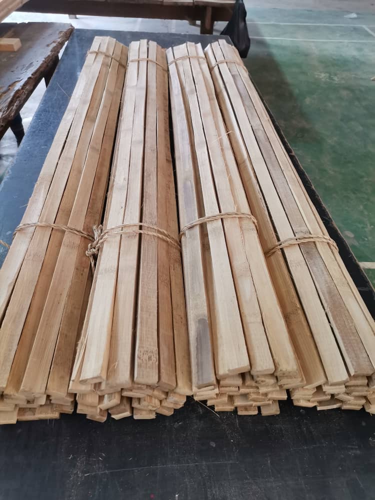 Bundles of precision-cut treated bamboo slats